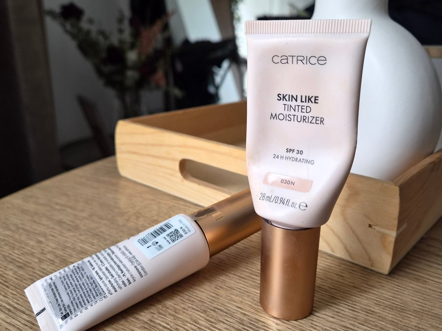 Catrice Skin Like Tinted Moisturizer SPF 30 in shade 030N displayed on a wooden surface